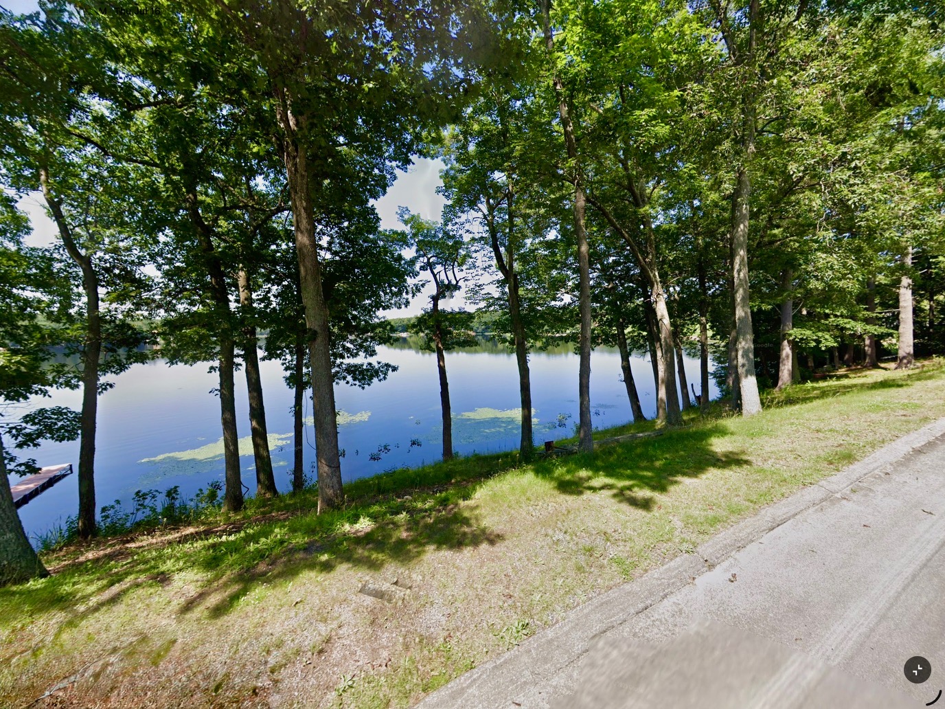 Looking through the trees at Captain’s Pond in Salem NH from the vantage point of Olde Village Road