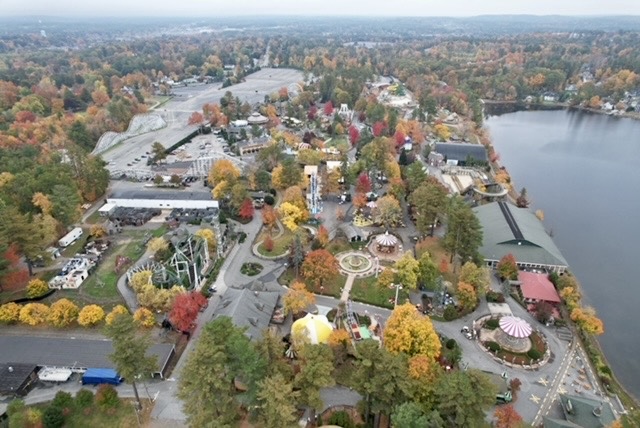 Aerial photo of Canobie Lake Park during the foliage season with colorful trees and rides