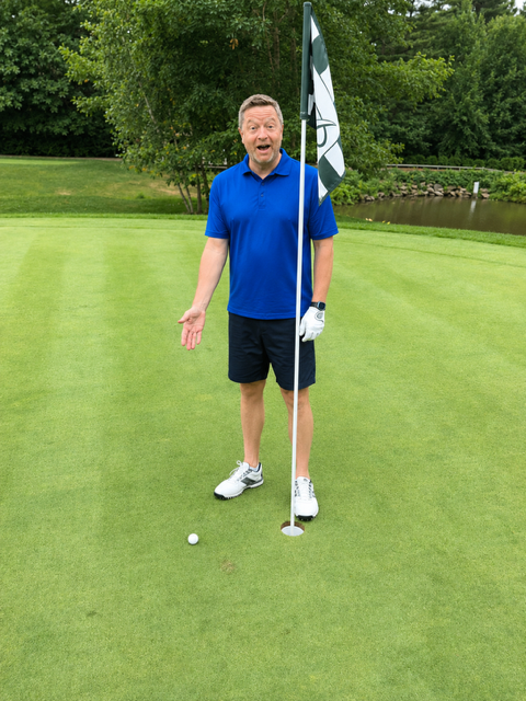 Josh Judge, Realtor, stands next to an amazing shot on the golf course. His first drive landed right near the hole on the green